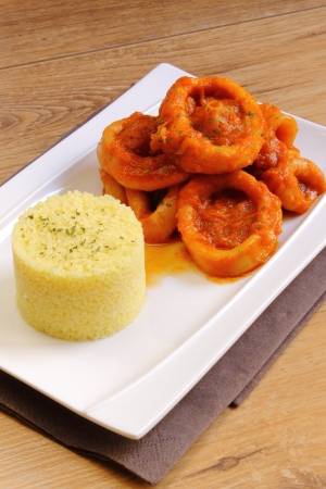 Calamari in tomato sauce with couscousの写真素材
