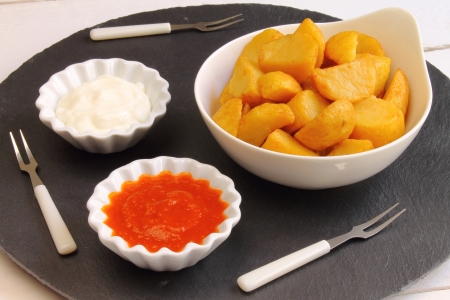 Patatas bravas is a Spanish tapa of potato with mayo and a hot sauceの写真素材