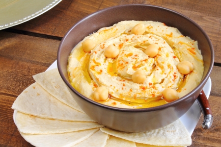 Hummus with olive oil, paprika and pita breadの写真素材