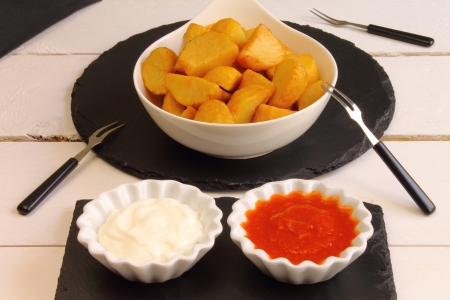 Patatas bravas, a Spanish tapa with fries and two saucesの写真素材