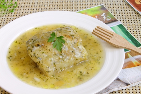 Fish fillet in a green sauceの写真素材