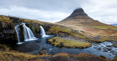 Waterfall and beautiful view at the kirkjufell mountain in iceland europe awesomeの写真素材