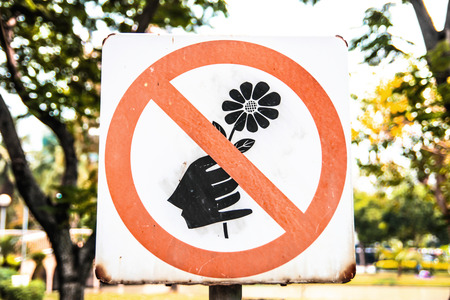 A red sign that tell you not to pick the flower in this areaの写真素材