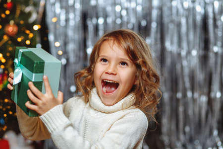 A little girl is happy with a giftの写真素材