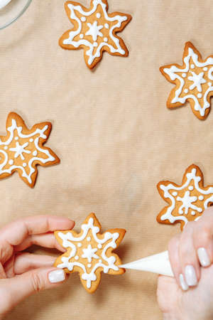 Christmas ginger cookies in the hands decorated with icing