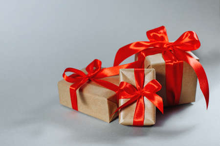 Gifts in kraft paper with red ribbon.の写真素材