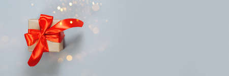 Gifts in kraft paper with red ribbon.の写真素材