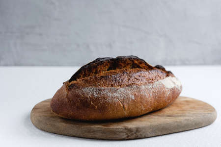 Rye bread on a board on a white tablecloth background