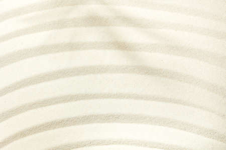 Off-focus background of light beach sand with space for text.