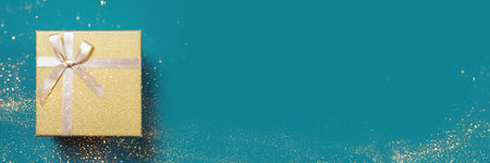 Golden gift holiday box on a blue background.の写真素材