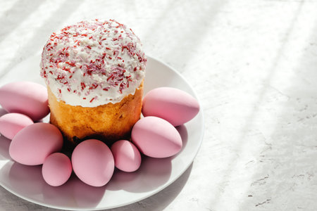 Easter cake garnished with sugar on a gray background. Pink-dyed Easter eggs.の写真素材