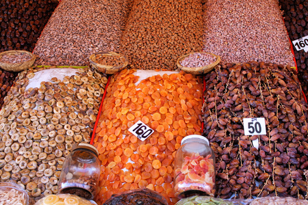 Moroccan market: african nuts and dried fruit stand in Marrakesh souk during the day.の写真素材