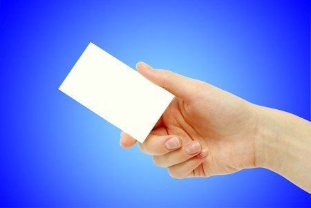 hand holding an empty business card over blueの写真素材