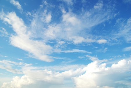 white fluffy clouds in the blue skyの写真素材
