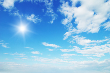white fluffy clouds in the blue skyの写真素材
