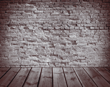 interior with an old brick wall and wooden floorの写真素材