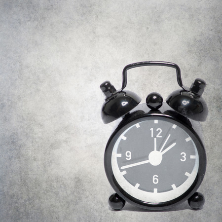 old alarm clock on old background textureの写真素材