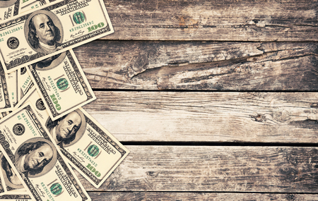 hundred dollar bills on wood tableの写真素材