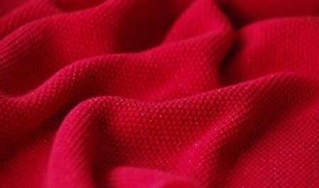 The texture of a knitted woolen fabric red.の写真素材