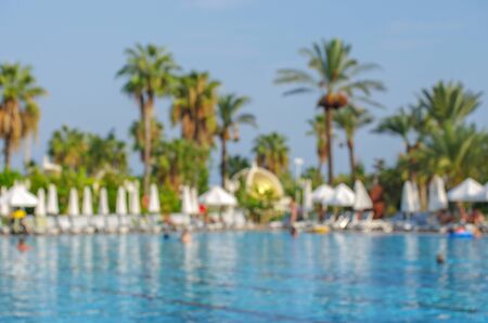 Abstract blur and defocus beautiful outdoor swimming pool in hotel resort for leisure relax in...