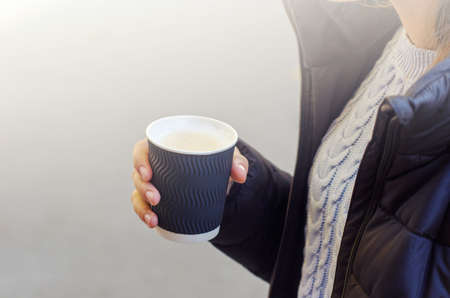 Cup of cappuccino in female hand