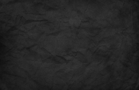 Crumpled black paper background imageの写真素材