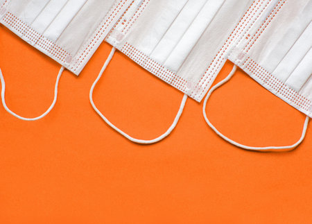 Protective medical face mask on a orange background