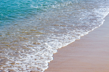 Soft wave of sea on sandy beach. background.