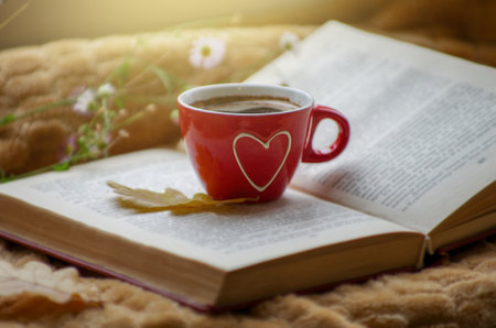 Hot coffee in the background of a window and autumn nature.の写真素材