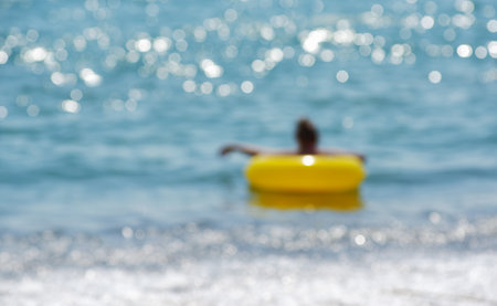 girl with a circle in the sea, defocused photo.の写真素材