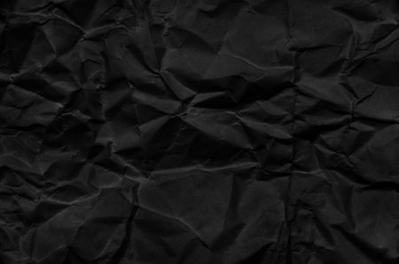 Crumpled black paper background imageの写真素材