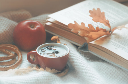 Hot tea in the background of a window and autumn nature.の写真素材