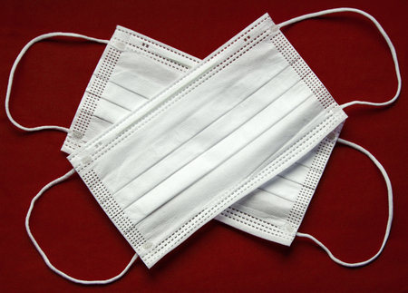 Coronavirus. Protective medical face mask on a red backgroundの写真素材