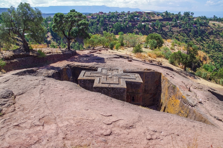 The Church of Saint George (Bete Giyorgis) is one of the eleven rock-hewn monolithic churches. The church was carved from a type of volcanic tuff. This is the sole orthodox material. It has been dated to the late 12th or early 13th century AD.   Eighth Woの写真素材