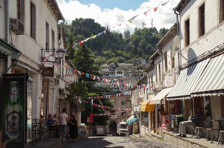 Gjirokastra, Albania - September 17, 2014: Street with cafes. Historical city center. Ottoman architecture.のeditorial素材