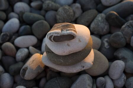 multi-colored sea pebbles of different sizes and shapesの写真素材
