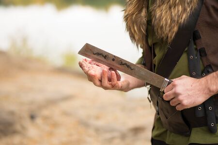 man holds a piece of meat in his hand
