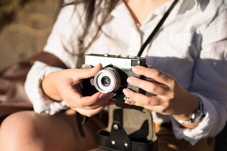 girl holding a camera in her hands for taking picturesの写真素材