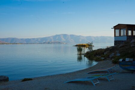 blue lake Sevan in Armenia with pebbles and ducksの写真素材