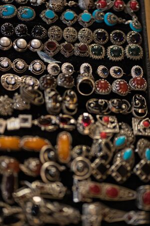 metal bracelets with multi-colored stones on the handの写真素材