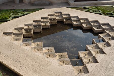 beige square concrete decoration with water