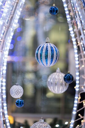 Round Christmas decorations - balls hang between a sparkling frameの写真素材