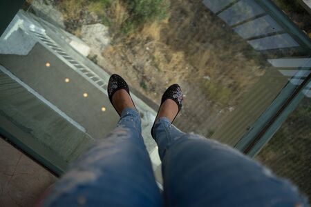 girl stands on a glass floor