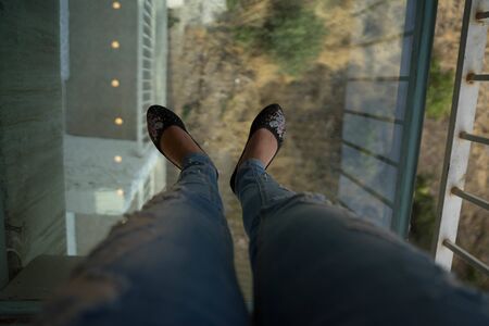 girl stands on a glass floorの写真素材