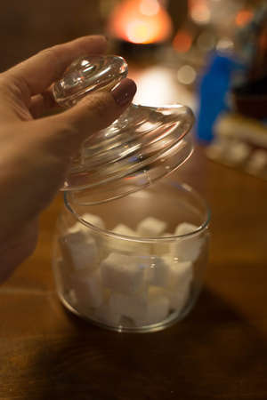 transparent glass jar with white sugar on the tableの写真素材