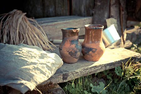 clay jugs stand on a wooden step