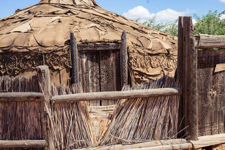 structures made of branches with a dome and a wicker fenceの写真素材