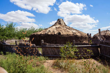 structures made of branches with a dome and a wicker fenceの写真素材