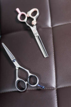 barber scissors lie on the armchair