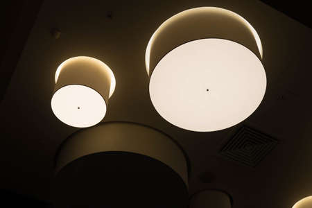 round lamps for room lighting, hanging from the ceilingの写真素材